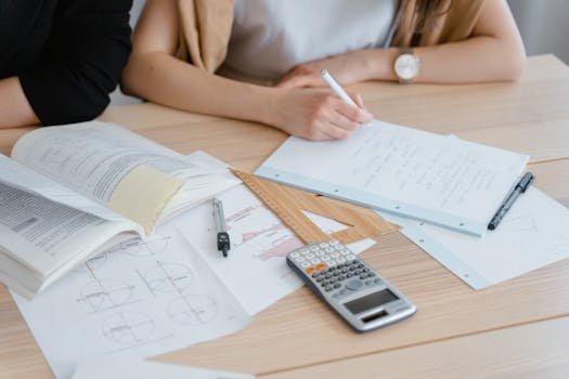 A student studying with a diagram-filled notebook