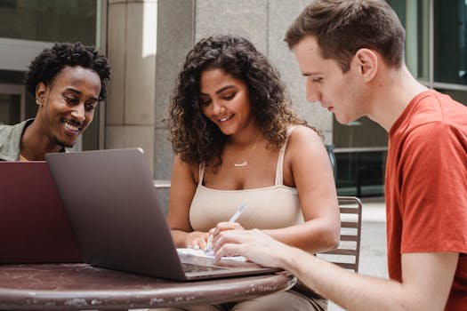 students working together on a laptop